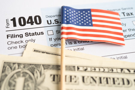 Tax Return form 1040 with USA America flag and dollar banknote, U.S. Individual Income.の写真素材