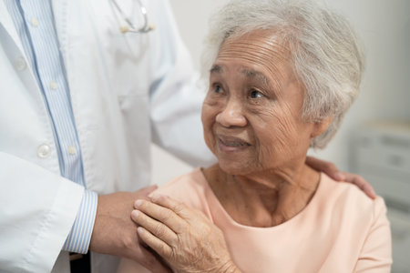 Caregiver holding hands Asian elderly woman patient with love, care, encourage and empathy at nursing hospital, healthy strong medical.の写真素材