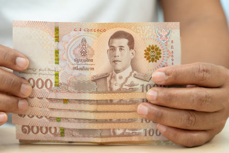 Asian woman holding Thai banknotes money, economy finance exchange trade investment.の写真素材