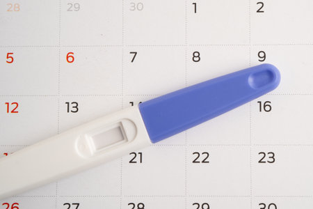Pregnancy test and birth control pills on calendar, contraception health and medicine.の写真素材