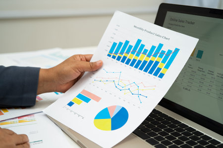 Asian business woman working with financial graph.