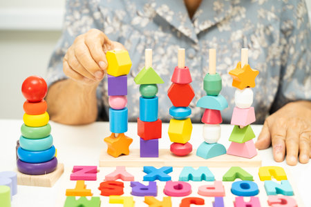 Asian elderly woman patient learn practical motor skills.