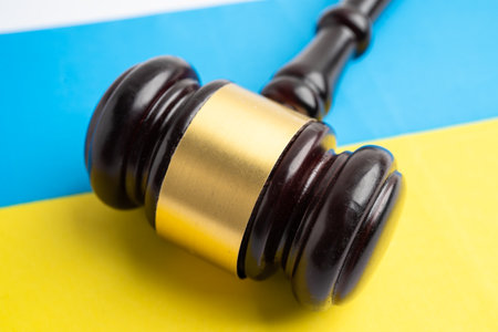 Ukraine flag with judge hammer, Law and justice court.の写真素材