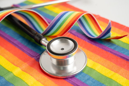 Stethoscope on rainbow flag background, symbol of LGBT pride month celebrate annual in June social, symbol of gay, lesbian, bisexual, transgender, human rights and peace.の写真素材