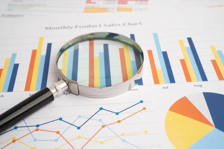 Magnifying glass on charts graphs paper. Financial development, Banking Account, Statistic,...