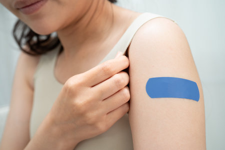 HPV, Human papillomavirus, Asian young woman receiving vaccine with blue bandage.の写真素材