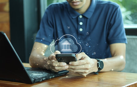 Mobile banking network concept. A young man using mobile phones with online payment icons.Digital marketing. Finance and Internet networking. financial technology.の写真素材