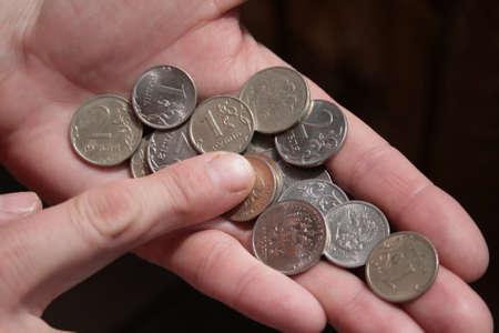 counting Russian metallic money, woman counts money in her hands