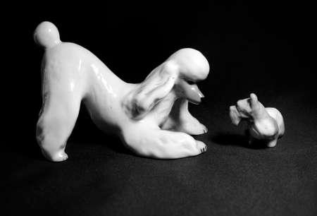 two china dogs look at each other on a black background