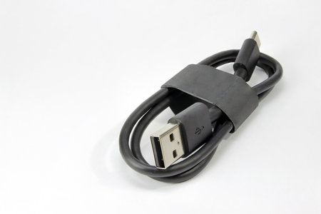 Close-up of a USB cable with standard A and micro-USB standard B connectors isolated on a white...