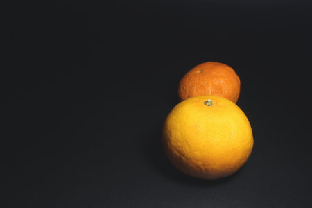 Orange fruit isolated on black background with copy space for text or designの写真素材