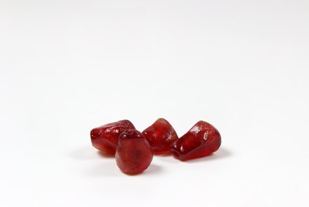 Pomegranate seeds on a white background, close-up