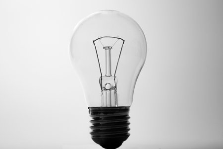 Light bulb on a white background, black and white photo, close-upの写真素材