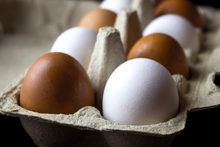 White and brown eggs in a cardboard box. selective focus.