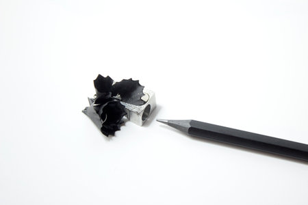 Pencil sharpener and shavings on a white background.の写真素材