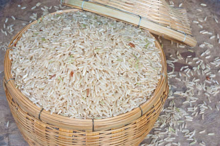 Brown rice grains in the bamboo basketの写真素材