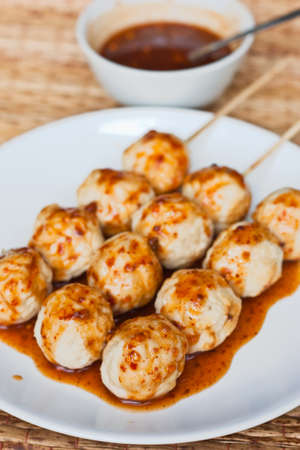 Roasted pork ball pour with sweet spicy sauceの写真素材