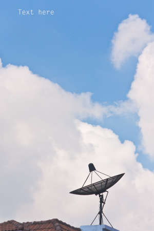 Satellite dish and cloudy blue skyの写真素材