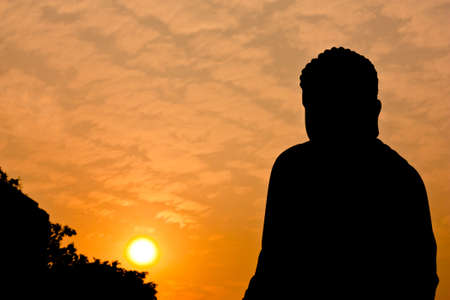 Silhouette view of Chinese buddha statue under twilight skyの写真素材