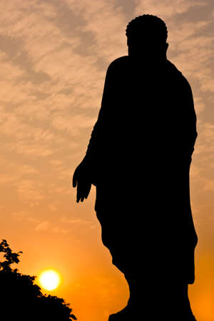 Silhouette view of Chinese buddha statue under twilight skyの写真素材