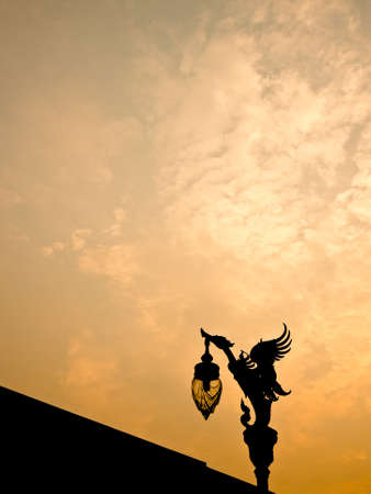 Silhouette view of Thai art style light pole under beautiful twilight skyの写真素材