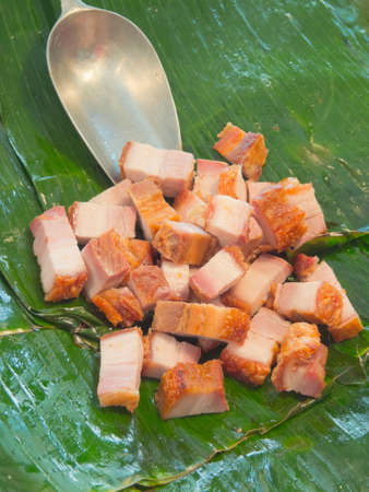 Fried streaky pork place on banana leafの写真素材