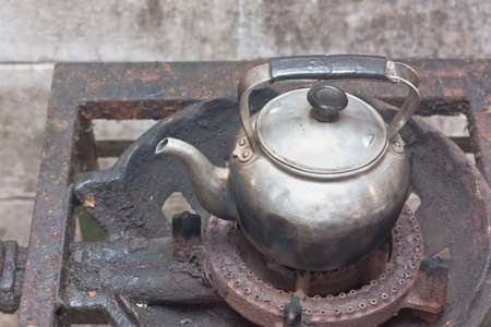 Old kettle on rusty gas stoveの写真素材