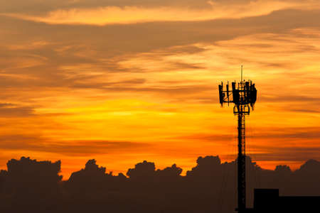 Silhouette view of cellphone antenna under twilight skyの写真素材