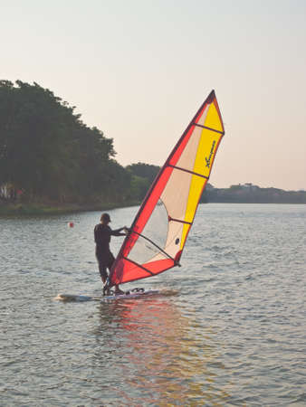 BANGKOK, THAILAND - MARCH 4, 2014 : An unnamed person enjoy his windsurfing in the lake of Nongbon Water Sports Center in Bangkok, Thailand.のeditorial素材