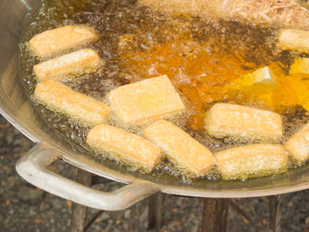 Deep frying tofu in boil vegetable oilの写真素材