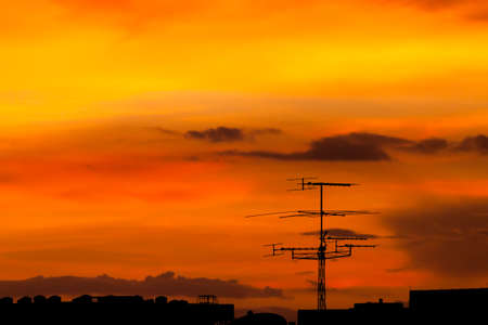 Silhouette view of classical television antenna under twilight skyの写真素材