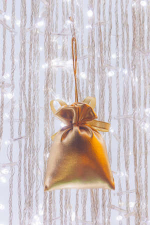 Ornamental golden velvet bag on cristmas treeの写真素材
