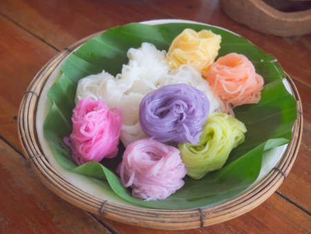 Thai style colorful rice noodles dye with natural herbs on banana leaf supportの写真素材