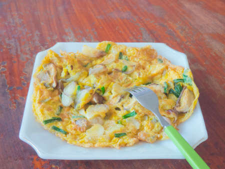Thai style omelet mixed with mushroom and herbsの写真素材