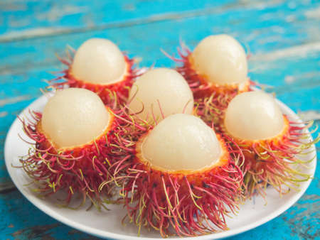Closeup of peeled rambutans served on white dish-Selective focusの写真素材