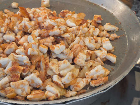 Thai style fried squid eggs cooking in a large panの写真素材