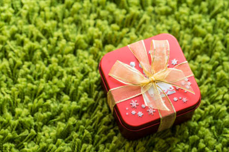 Red gift box on green backgroundの写真素材