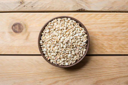 Millet seeds in can placed on a wooden backgroundの写真素材