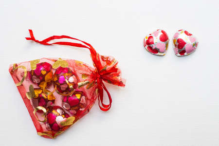 Close up of Chocolate heart-shaped in red bag on white backgroundの写真素材