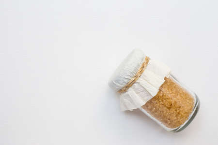 Sugar in glass jar on white canvasの写真素材