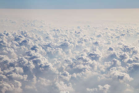 Clouds and sky as seen through window of an aircraft