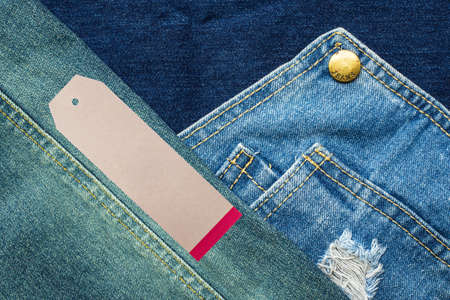 Rip denim jeans background with seam of jeans fashion design and tagの写真素材