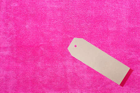 Close up of Pink microfiber cloth with tag for backgroundの写真素材