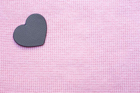 leather heart-shaped on pink fabric backgroundの写真素材