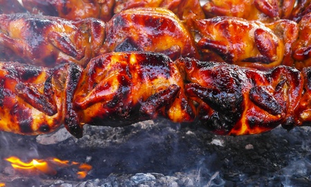 grill chicken cooking on fire charcoal for delicious mealの写真素材