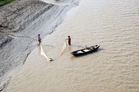 south 24 pargana west bengal india on march 25th 2017: Fishing couple are busy to collecting fish in...