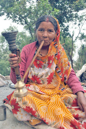 harsil uttarakhand india on may 25th 2012:We all know that smoking is harmful to health. Yet we smoke knowingly. In the rural areas of Nainital, women also smoke.のeditorial素材