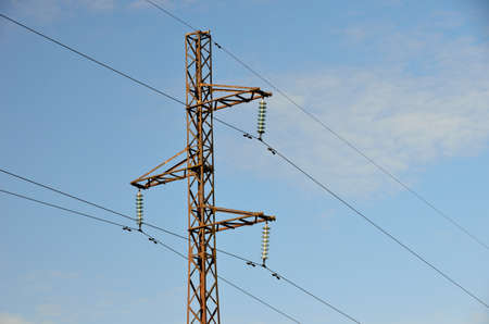 Electrical transmission pylon. High voltage. Blue sky background.