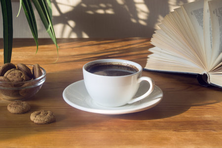 Still life with a Cup of coffee, cookies and a book. The atmosphere of a cozy morning Breakfast at...