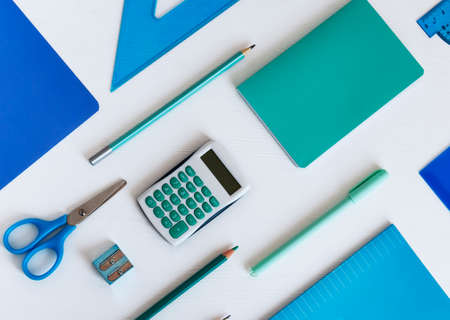 Background with blue office supplies. Folder, notebook, notebook, pencil in different shades of the same colorの写真素材